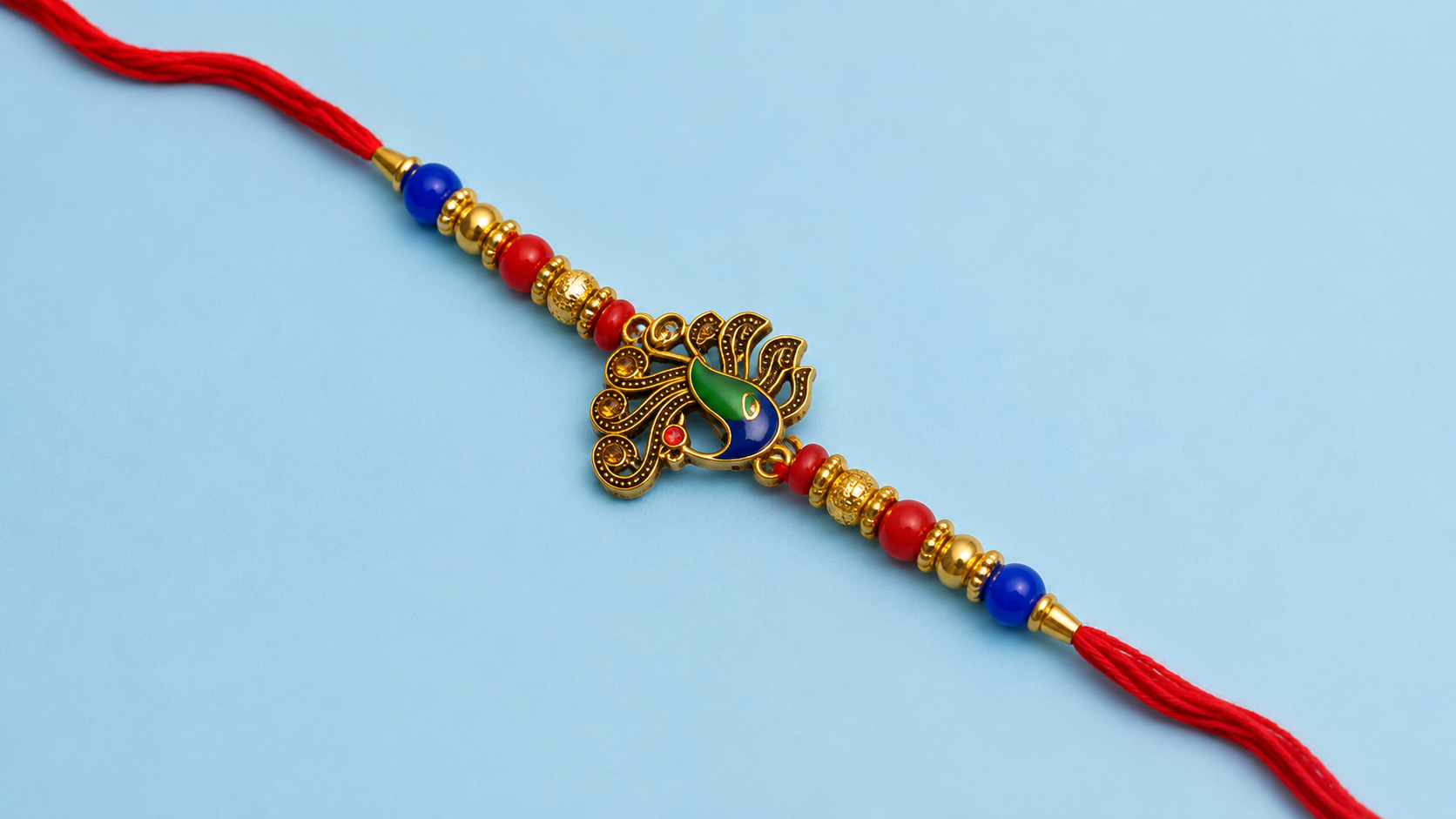 Peacock Designer Rakhi with Red Thread